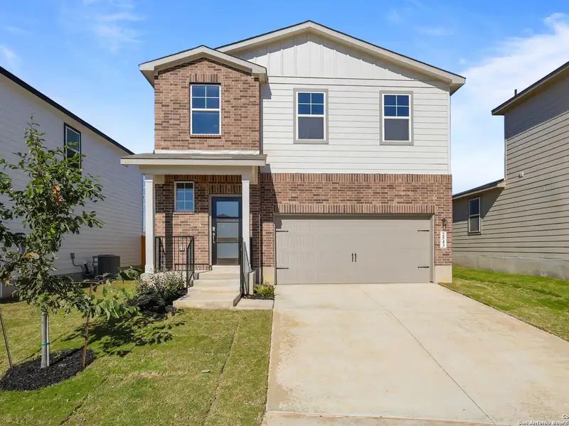Front exterior of a new home in Applewhite Meadows, San Antonio, TX, highlighting curb appeal (Image 2). Front exterior of a new home in Applewhite Meadows, San Antonio, TX, highlighting curb appeal (Image 2).