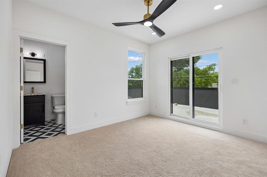 Bedroom featuring carpet flooring, a modern ceiling fan with brass accents, and recessed lighting Bedroom featuring carpet flooring, a modern ceiling fan with brass accents, and recessed lighting