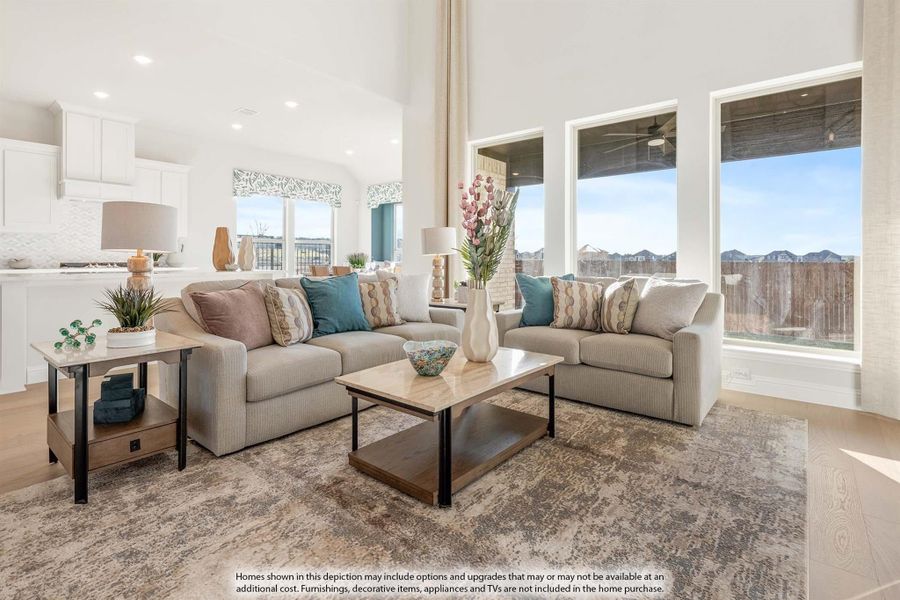 Open living room with high ceilings, beige sofas, wood coffee table, and large windows with natural light Open living room with high ceilings, beige sofas, wood coffee table, and large windows with natural light
