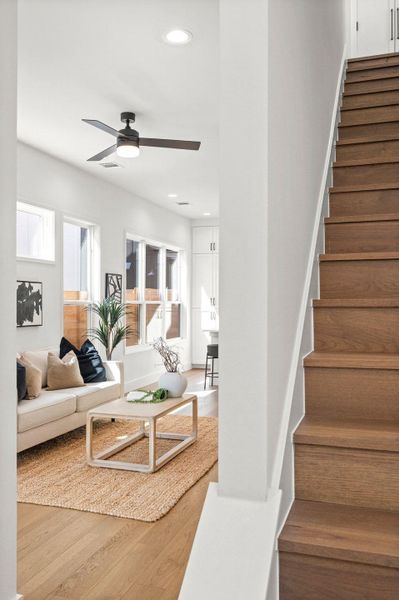 Living room with wood finished floors, recessed lighting, and a ceiling fan