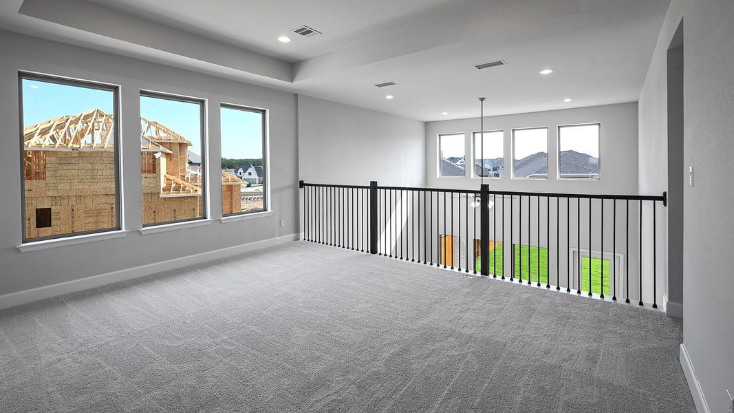 Carpeted empty room with recessed lighting and a tray ceiling