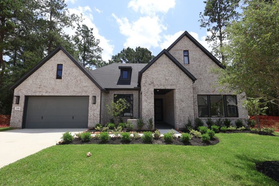Front exterior of a new home in The Woodlands Hills - Premier Collection, Willis, TX, highlighting curb appeal (Image 2). Front exterior of a new home in The Woodlands Hills - Premier Collection, Willis, TX, highlighting curb appeal (Image 2).