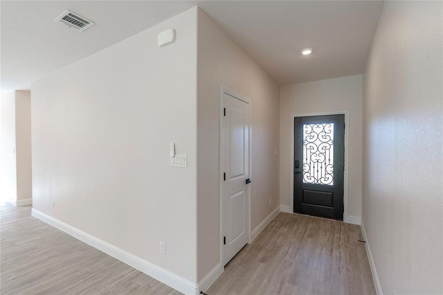 Foyer entrance with light hardwood / wood-style floors