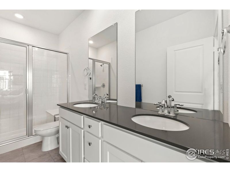 Primary bath with dual vanities and walk in shower