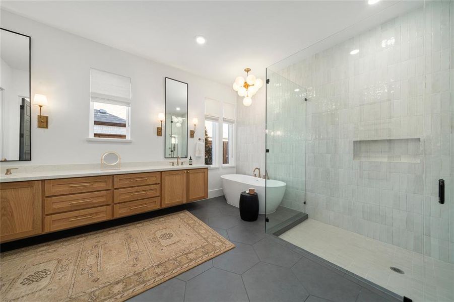 Bathroom featuring tile patterned floors, vanity, and independent shower and bath