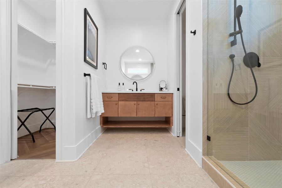 Another angle of the expansive primary bathroom reveals a second vanity and a door to the private toilet area. Just steps away, a walk-in closet adds to the suite’s refined functionality—mirroring the one on the opposite end. This dual closet feature enhances the flow and elegance of the space, delivering both comfort and elevated convenience. Another angle of the expansive primary bathroom reveals a second vanity and a door to the private toilet area. Just steps away, a walk-in closet adds to the suite’s refined functionality—mirroring the one on the opposite end. This dual closet feature enhances the flow and elegance of the space, delivering both comfort and elevated convenience.