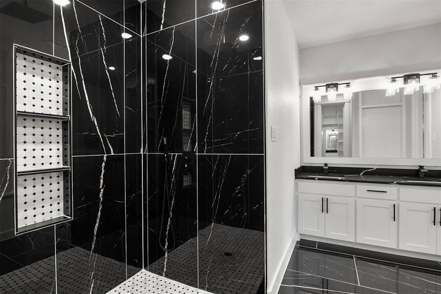 Bathroom with vanity and a shower with door