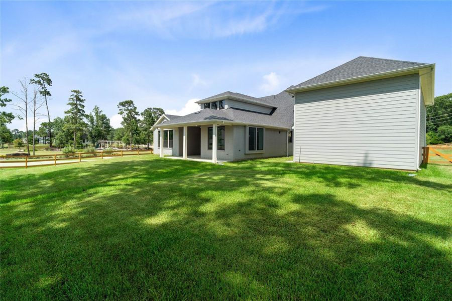 This gorgeous home sits on a corner lot with plenty of green space. Across the street are walking trails and the community lake.
