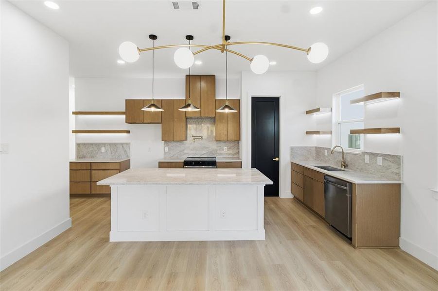 Kitchen featuring open shelves, decorative backsplash, decorative light fixtures, light stone countertops, and a kitchen island