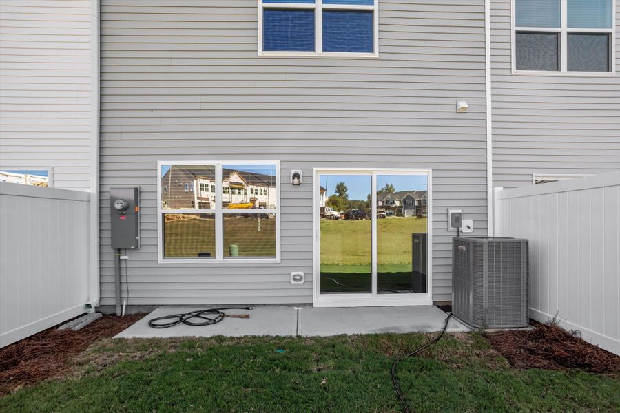 Exterior details and patio area of a home in West Main Townhomes, Sanford (Image 3).