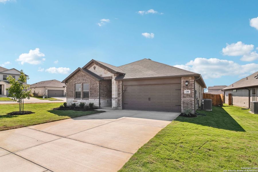 Front exterior of a new home in Legendary Trails - Classic Series, Cibolo, TX, highlighting curb appeal (Image 1).
