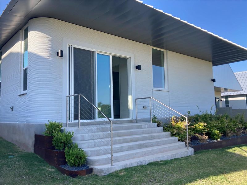Exterior details and patio area of a home in Wolf Ranch: Genesis Collection, Georgetown (Image 2). Exterior details and patio area of a home in Wolf Ranch: Genesis Collection, Georgetown (Image 2).