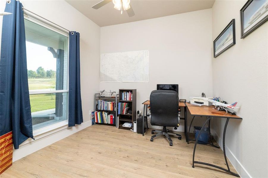 Office with light wood finished floors and baseboards