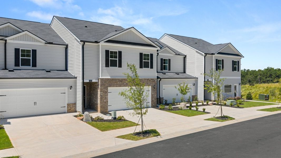 Front exterior of a new home in Rushing Waters Townhomes, North Augusta, SC, highlighting curb appeal (Image 1). Front exterior of a new home in Rushing Waters Townhomes, North Augusta, SC, highlighting curb appeal (Image 1).