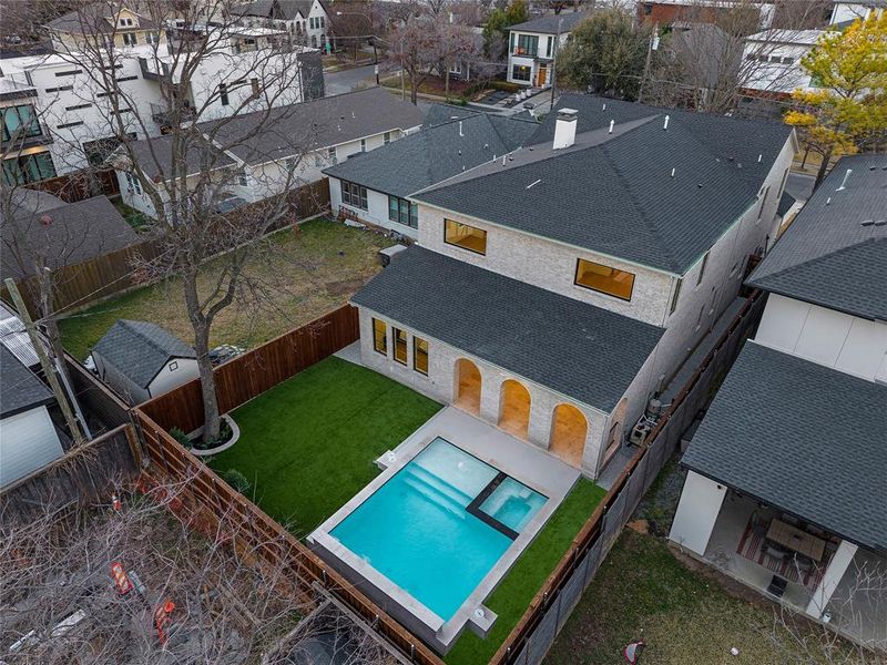 Aerial perspective of suburban area featuring a pool Aerial perspective of suburban area featuring a pool