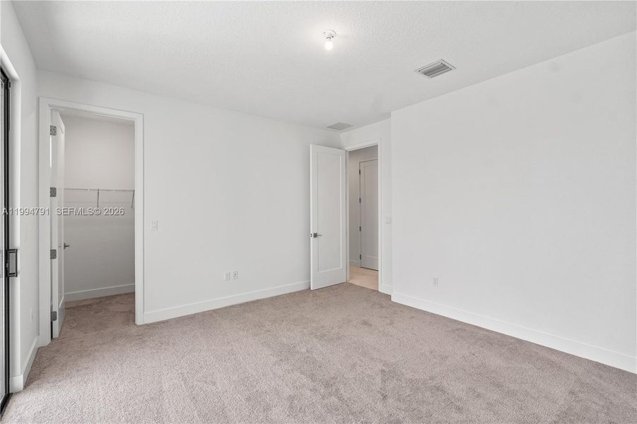 2nd bedroom with balcony and walk-in closet