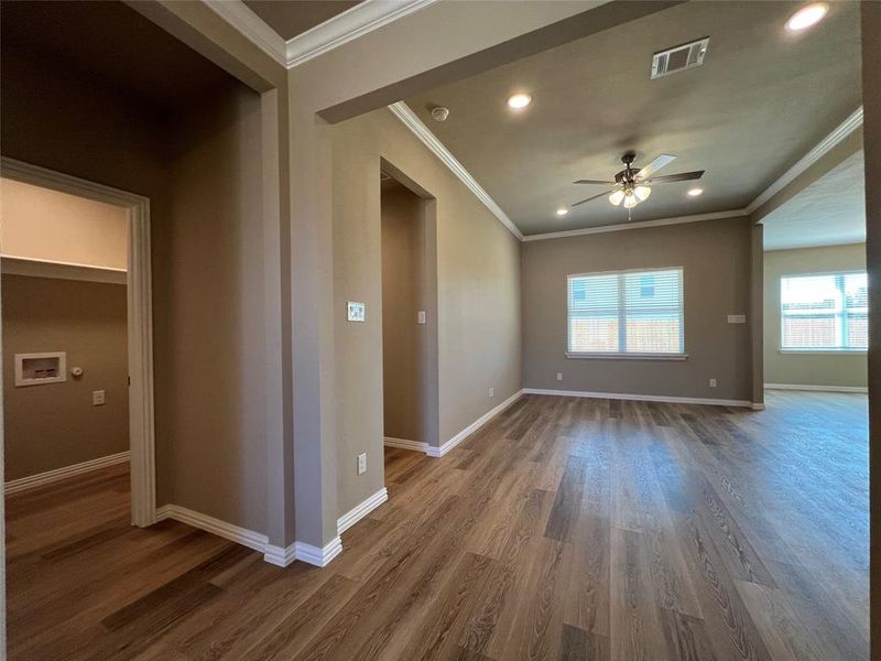 Spare room featuring ceiling fan, crown molding, and hardwood / wood-style floors