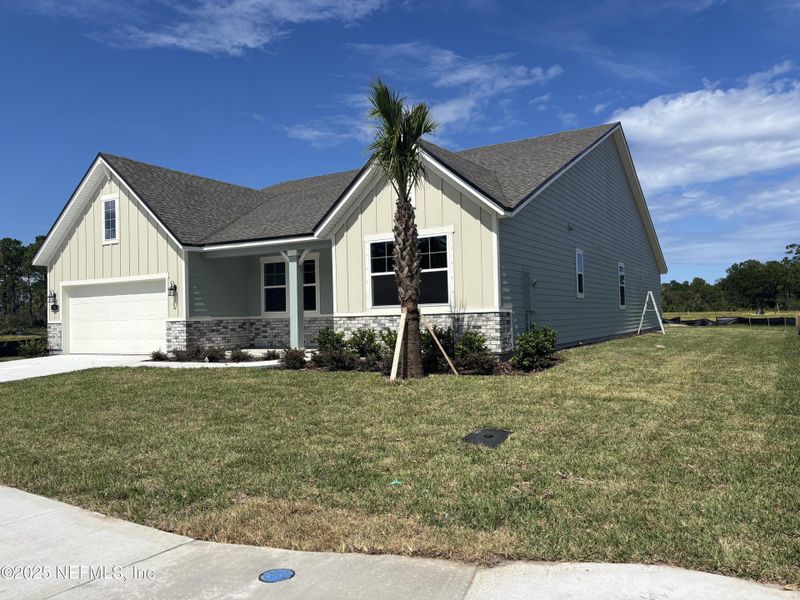Front exterior of a new home in The Cypress Series at Reserve East, Flagler Beach, FL, highlighting curb appeal (Image 17).
