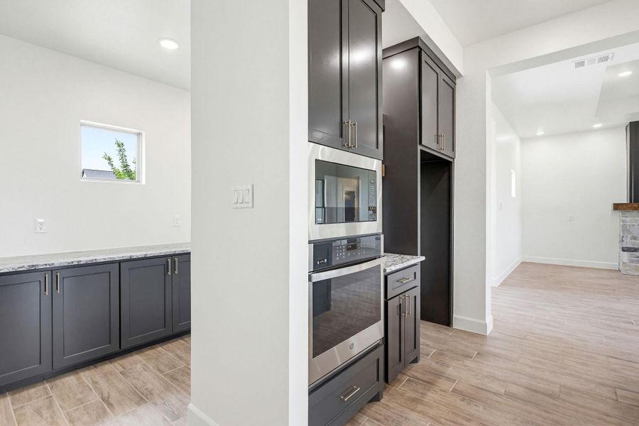A well-appointed kitchen features dark cabinetry, integrated stainless steel appliances, and sleek countertops, perfect for culinary endeavors. A well-appointed kitchen features dark cabinetry, integrated stainless steel appliances, and sleek countertops, perfect for culinary endeavors.