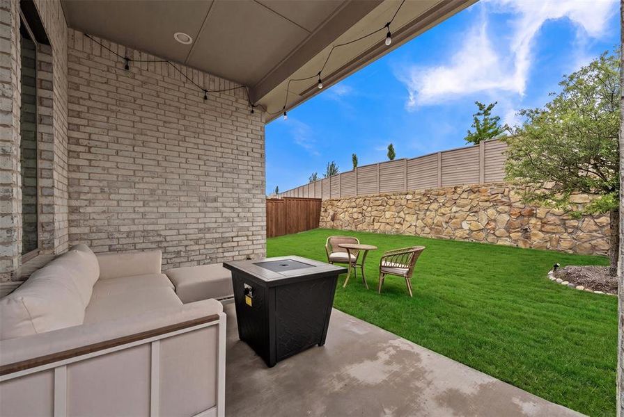 Covered patio featuring string lighting and a light brick exterior Covered patio featuring string lighting and a light brick exterior