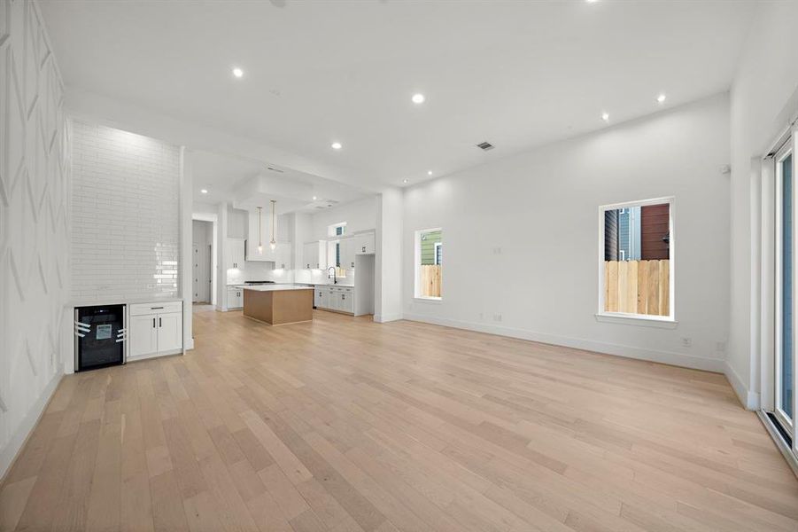 Living/dining room also features a convenient bar area with wine cooler and additional storage! (Photo is of a previously completed home.)