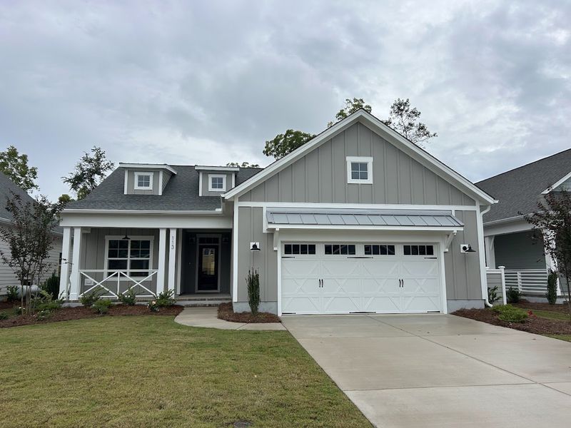 Front exterior of a new home in Riverside Cove, Wilmington, NC, highlighting curb appeal (Image 1).