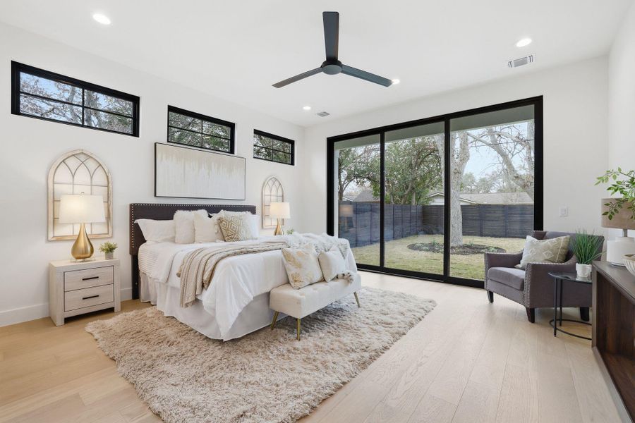Bedroom featuring access to exterior, light wood-style flooring, a ceiling fan, and recessed lighting