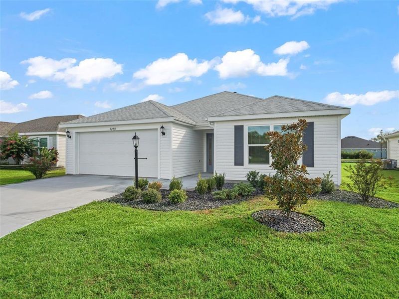 Front exterior of a new home in , The Villages, FL, highlighting curb appeal (Image 2).