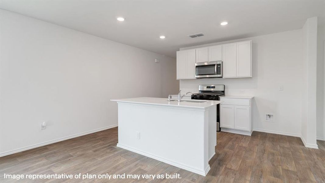 Kitchen featuring white cabinets, stainless steel appliances, recessed lighting, a kitchen island with sink, and dark wood finished floors
