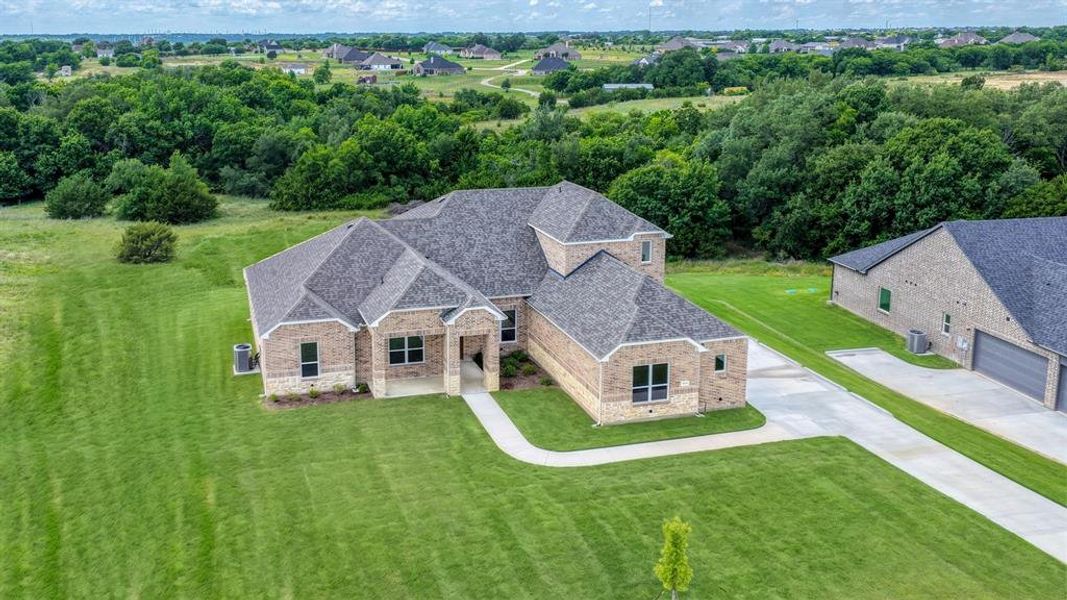 Front exterior of a new home in Woodland Lakes Estates, Weatherford, TX, highlighting curb appeal (Image 23).