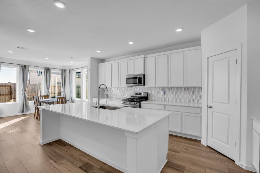 Kitchen & Dining: A light-filled kitchen centered around a large island designed for everyday use and effortless hosting. Crisp cabinetry, clean finishes, and an open flow to the dining area make this space feel inviting, functional, and well balanced. Kitchen & Dining: A light-filled kitchen centered around a large island designed for everyday use and effortless hosting. Crisp cabinetry, clean finishes, and an open flow to the dining area make this space feel inviting, functional, and well balanced.