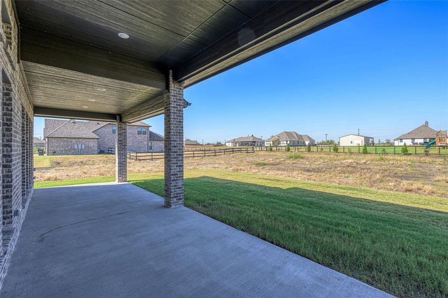 Fenced backyard featuring a patio area and a residential view