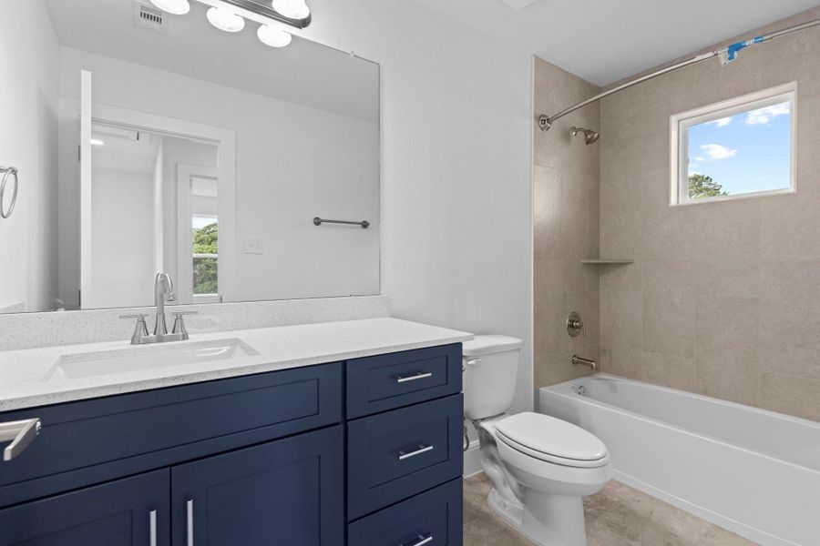 The guest bathroom also is gorgeous with the custom shaker cabinetry!   soft-close cabinets, deep undermount sink, beautiful quartz countertops, tub and shower combination with tile from ceiling to floor.  Transom window allows all the natural light in!  Wow what a home to call home!