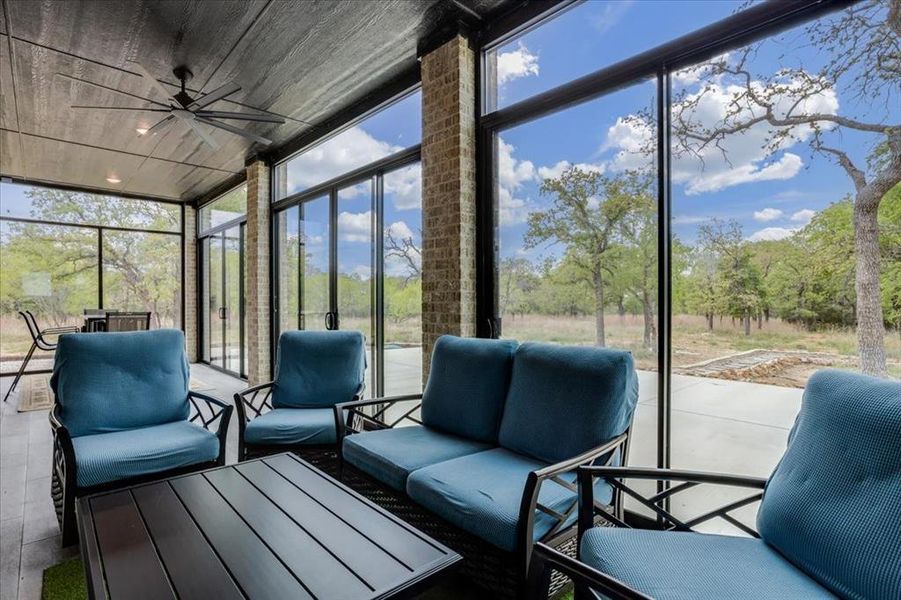 Sunroom with outdoor seating, ceiling fan, and plenty of natural light