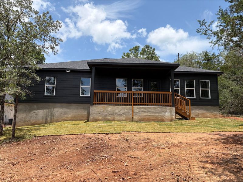 A striking dark-clad residence with a welcoming rear deck and newly laid sod awaits. A striking dark-clad residence with a welcoming rear deck and newly laid sod awaits.