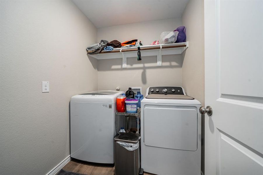Laundry area with washer and dryer and dark wood-type flooring Laundry area with washer and dryer and dark wood-type flooring