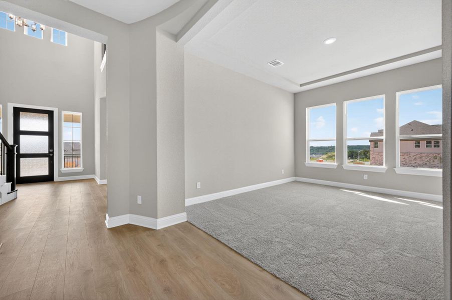 Empty room featuring light wood-type flooring and stairs
