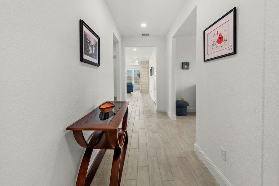 From the front entry, a hallway leads past the second bedroom/bathroom to the flex room.