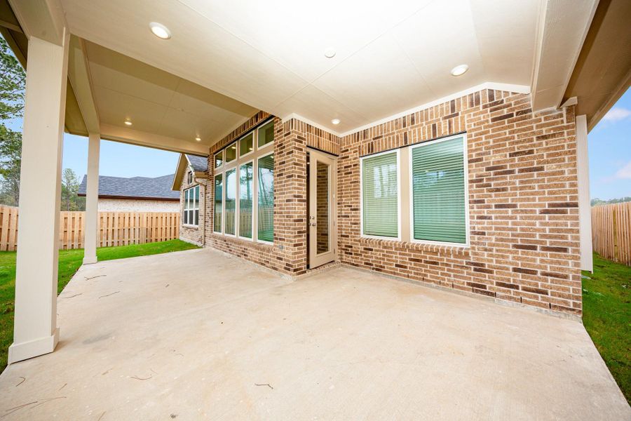Step outside to the covered rear patio, the perfect extension of your indoor living space for year-round enjoyment.