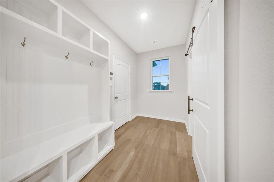 Mudroom featuring light wood-style flooring and baseboards Mudroom featuring light wood-style flooring and baseboards