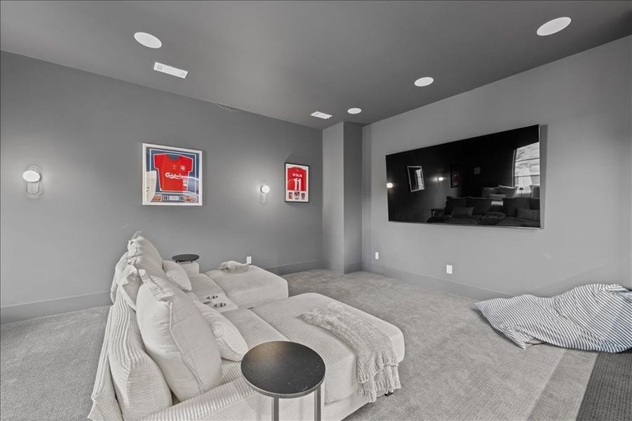 Carpeted home theater room featuring baseboards and recessed lighting