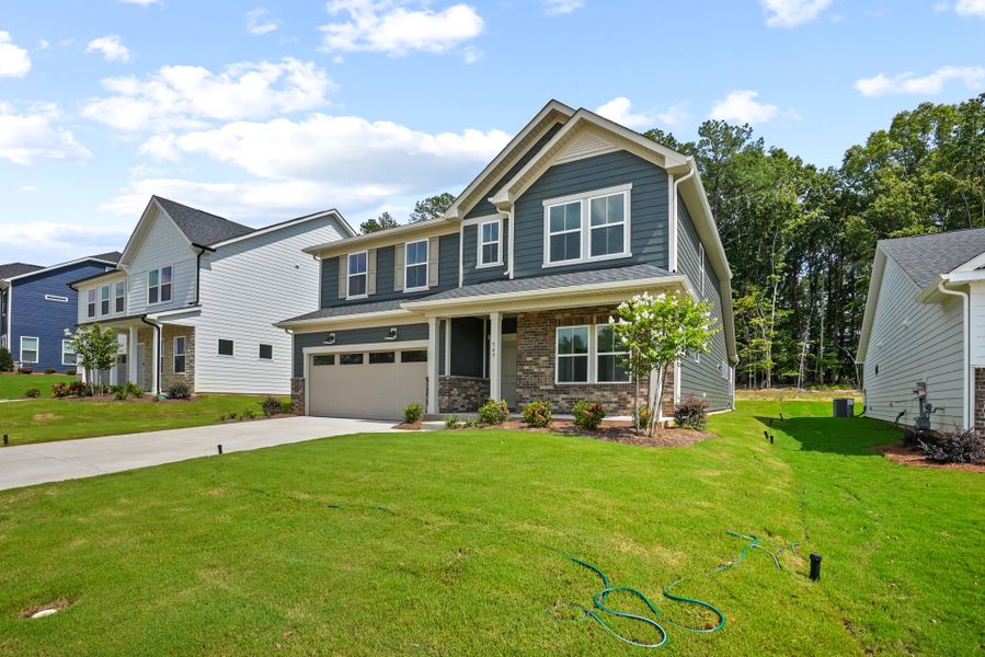 Front exterior of a new home in Michaux Gardens, Belmont, NC, highlighting curb appeal (Image 34). Front exterior of a new home in Michaux Gardens, Belmont, NC, highlighting curb appeal (Image 34).