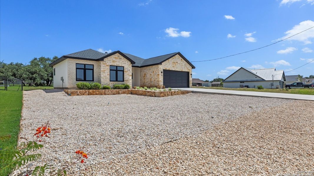 Front exterior of a new home in , Blanco, TX, highlighting curb appeal (Image 29).