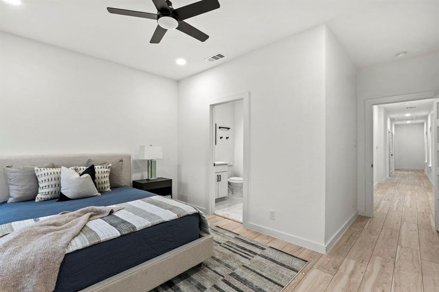 Bedroom featuring light wood finished floors, recessed lighting, ensuite bath, baseboards, and ceiling fan Bedroom featuring light wood finished floors, recessed lighting, ensuite bath, baseboards, and ceiling fan