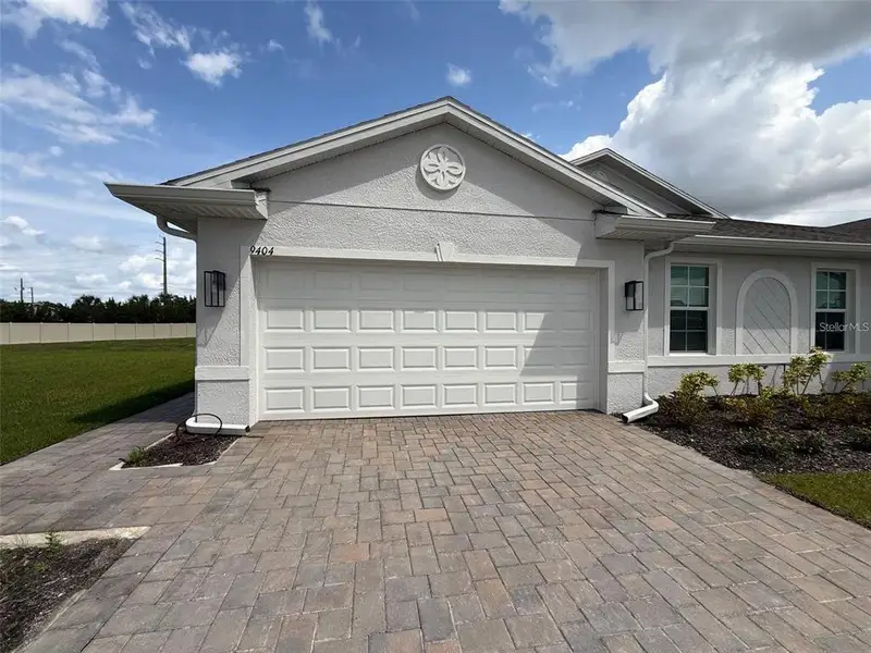 Front exterior of a new home in , Punta Gorda, FL, highlighting curb appeal (Image 1). Front exterior of a new home in , Punta Gorda, FL, highlighting curb appeal (Image 1).