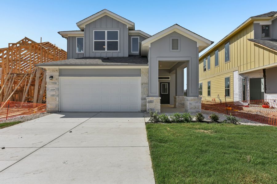 Front exterior of a new home in Saddle Ridge at Wildhorse Ranch, Austin, TX, highlighting curb appeal (Image 1). Front exterior of a new home in Saddle Ridge at Wildhorse Ranch, Austin, TX, highlighting curb appeal (Image 1).