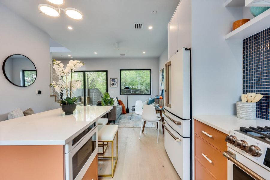 Pro-grade GE Cafe Series appliances tucked into sleek granite—because your kitchen should work as hard as it looks