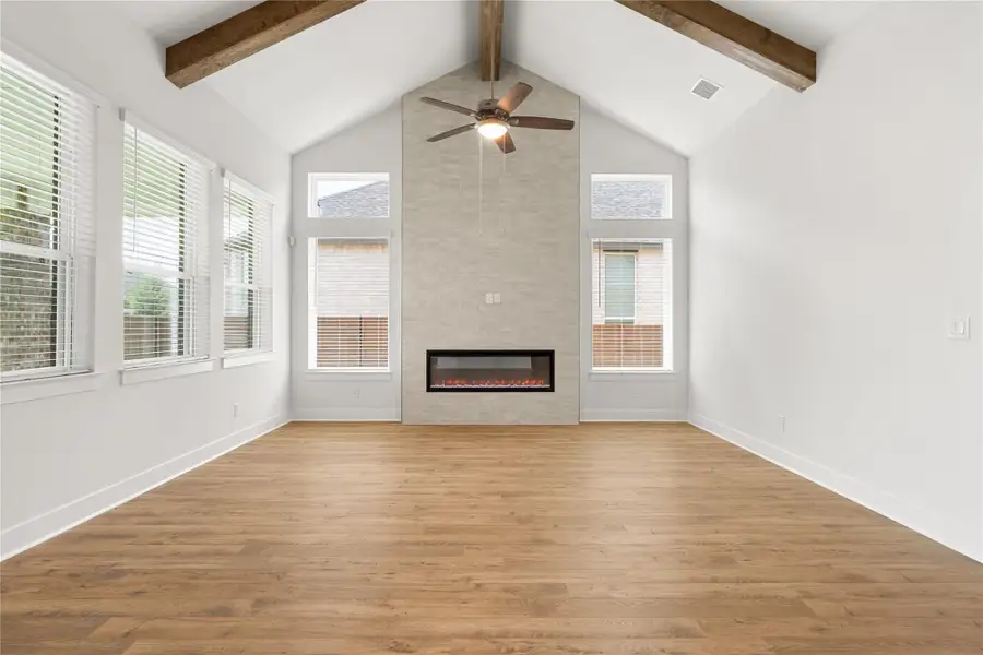 Another view of the living area with high vaulted ceilings, exposed beams, and a contemporary fireplace. Another view of the living area with high vaulted ceilings, exposed beams, and a contemporary fireplace.