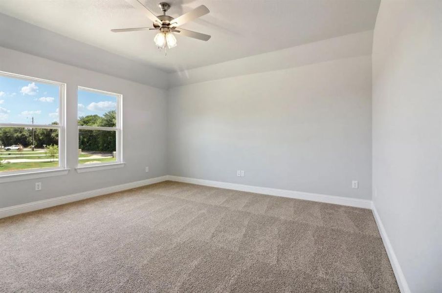 Spare room featuring carpet flooring and ceiling fan