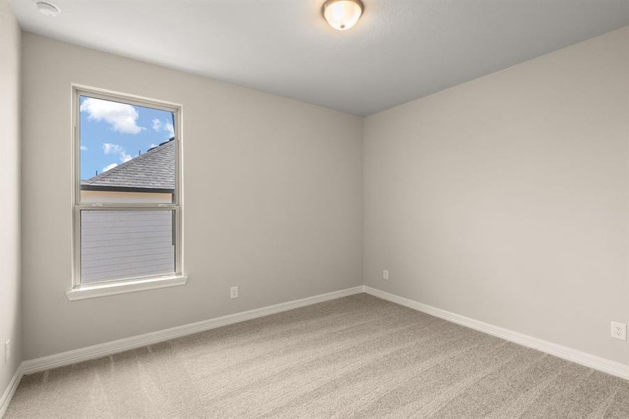 Your secondary bedroom features plush carpet, fresh paint, closet, and a large window that lets in plenty of natural lighting.